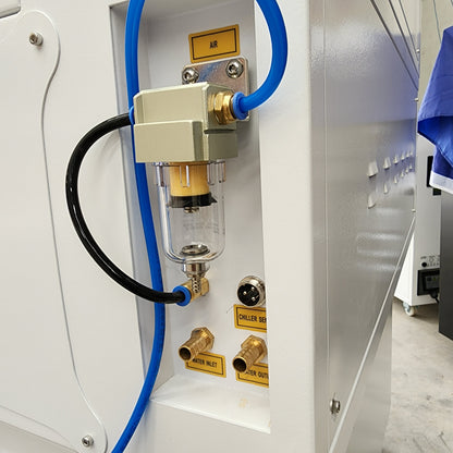 Close-up of J750 Laser Machine 90-100W RECI T2 showing air and water connection details.
