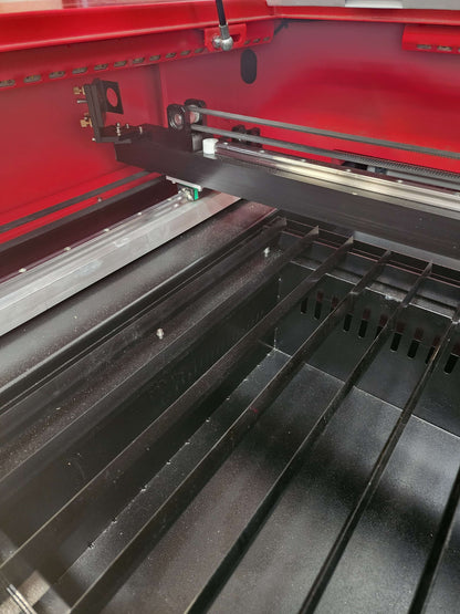 Inside view of R960 Laser Machine 100W RECI W2 showing the laser cutting workspace and machinery.