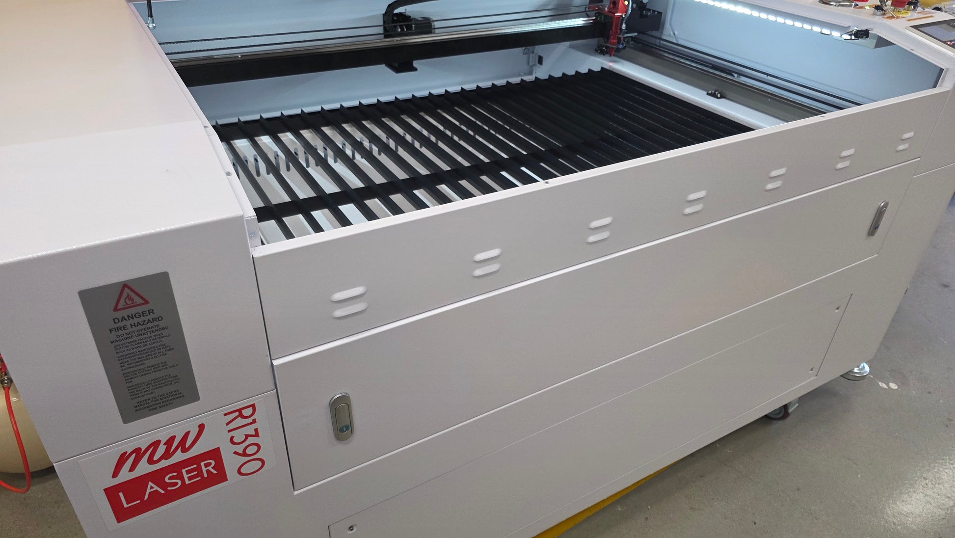 R1390 Laser Machine RECI W4 showing the cutting bed and safety features for reliable engraving and cutting applications.