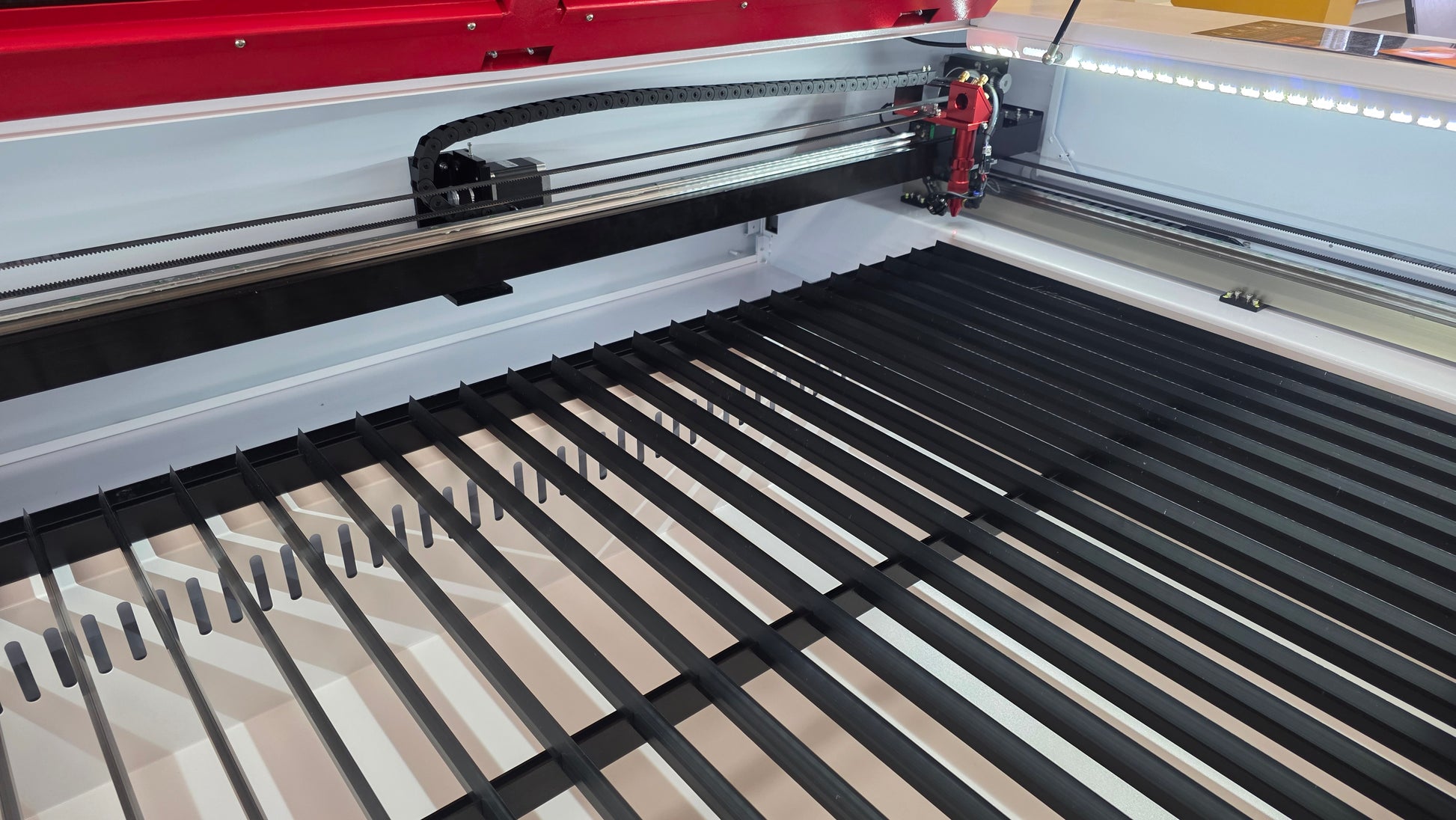 Interior view of R1390 Laser Machine RECI W4 showing the laser cutter mechanism and work area.