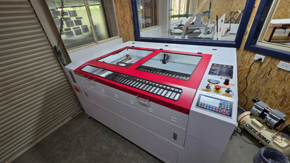 R1390 Laser Machine RECI W4 in a workshop setting, showcasing its controls and enclosed design.