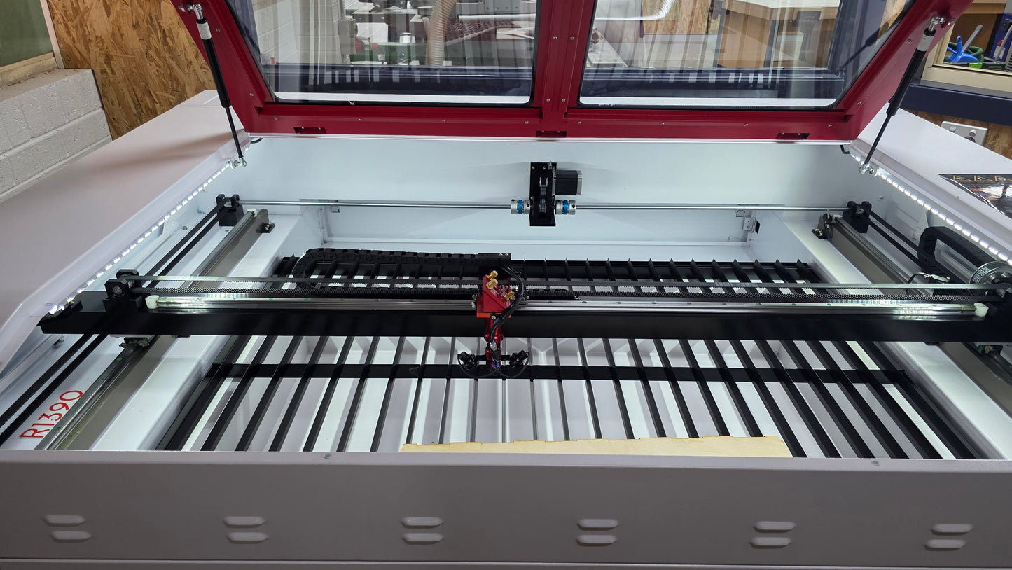 Interior view of the R1390 Laser Machine RECI W4 showing the laser cutting area and components.
