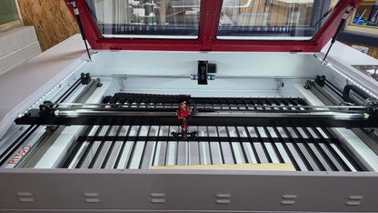 Interior view of the R1390 Laser Machine RECI W4 showing the laser cutting area and components.