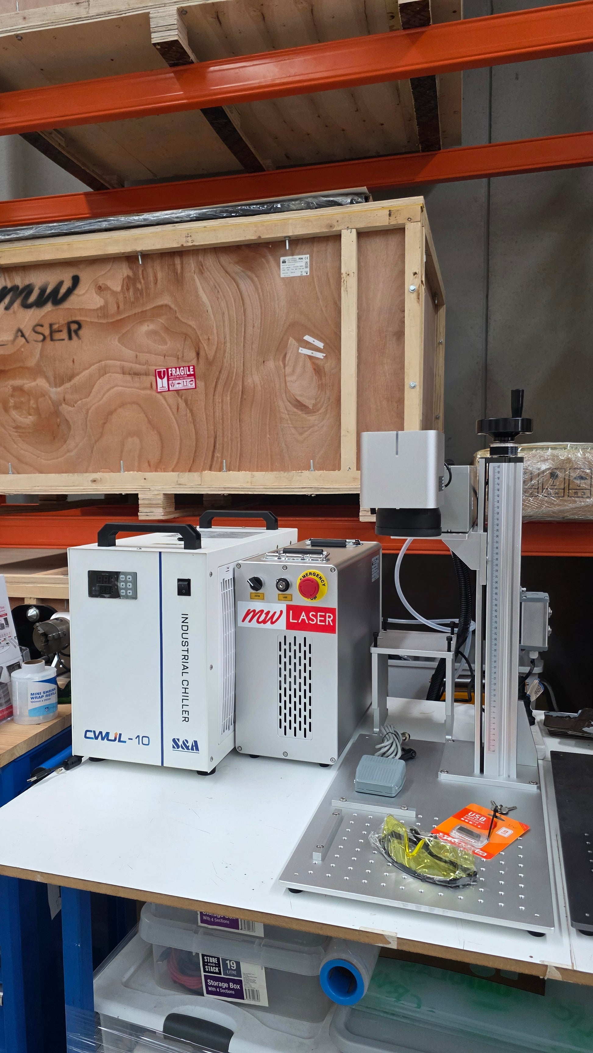 UV Laser Marking Machine RM-UV10X with control unit on a workbench in a workshop setting.