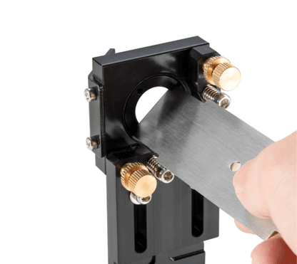 Laser Lens Mirror Removal Tool being used to adjust lens components on a tool holder for laser lenses.