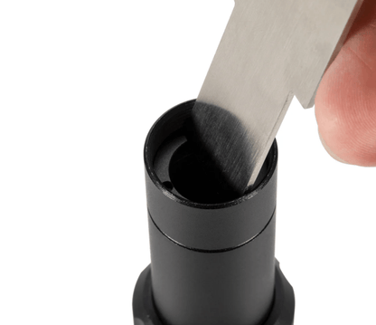 Laser Lens Mirror Removal Tool inserting a blade into lens tube for easy mirror removal.