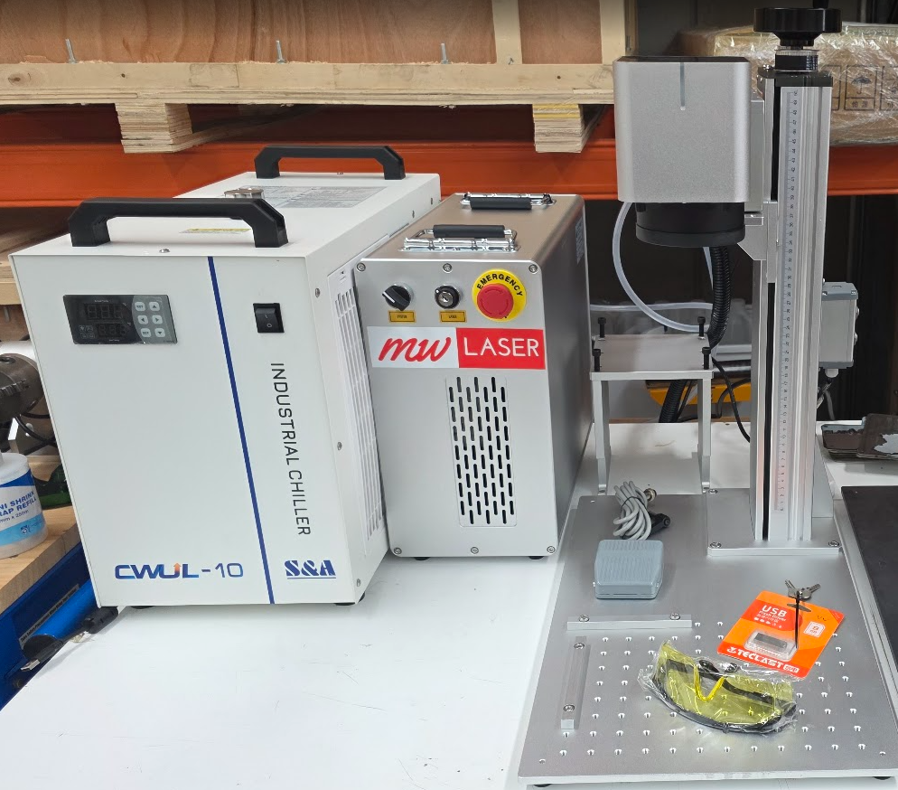 UV Laser Marking Machine RM-UV10X setup with industrial chiller and safety goggles on workbench.